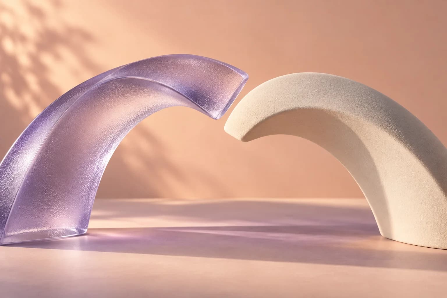 Two sculptural glass and ceramic arches meeting in a warm studio setting